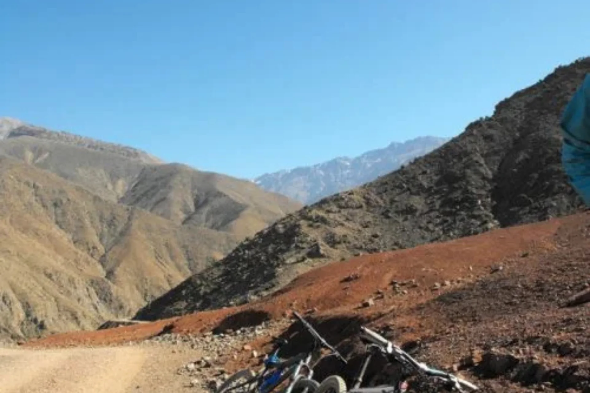 Scenic High Atlas mountain valley with a remote Berber village and snow-dusted peaks.